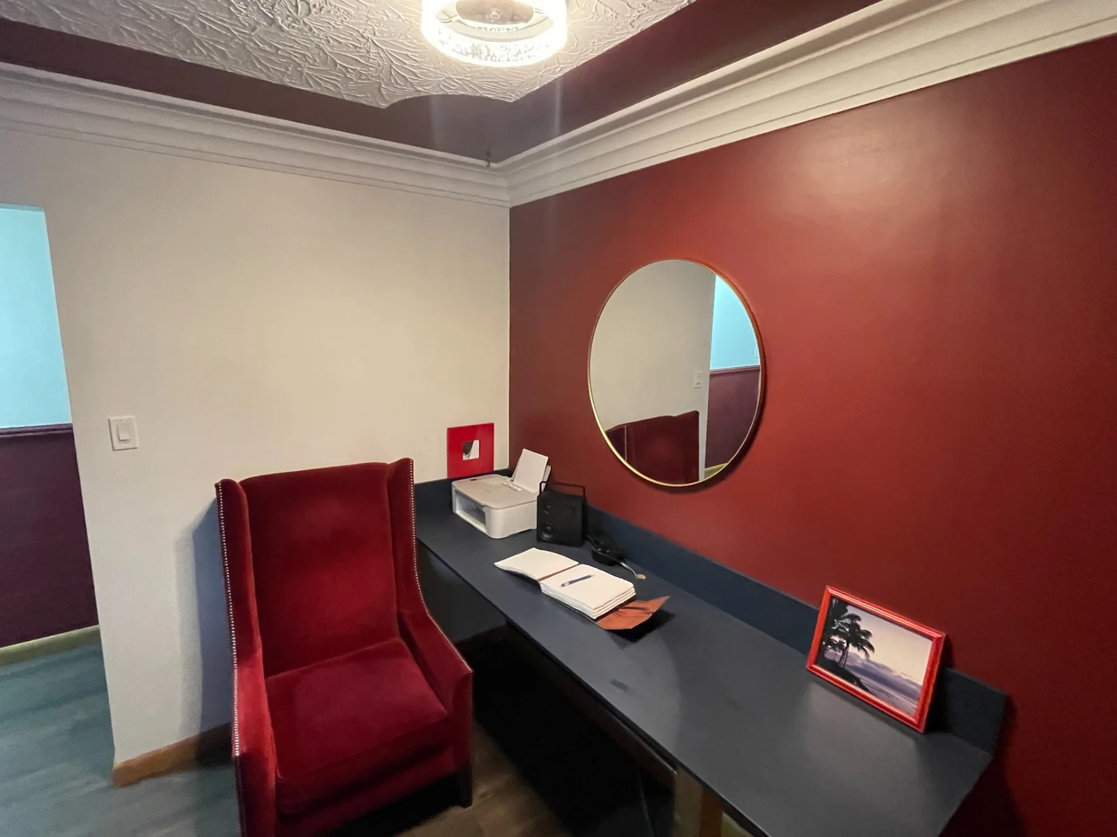 Dedicated desk with burgundy chair and mirror in Merlot House