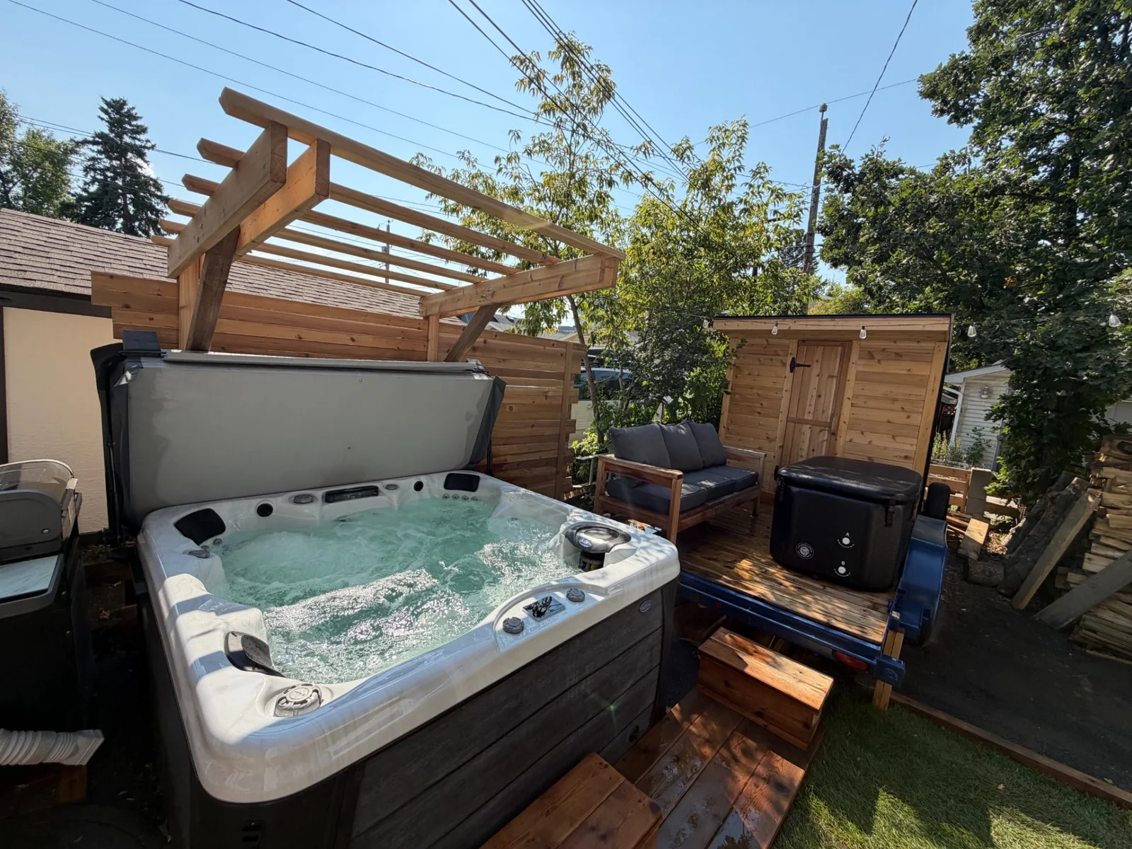 Open hot tub beside the cedar sauna and cold-plunge lounge at Merlot House